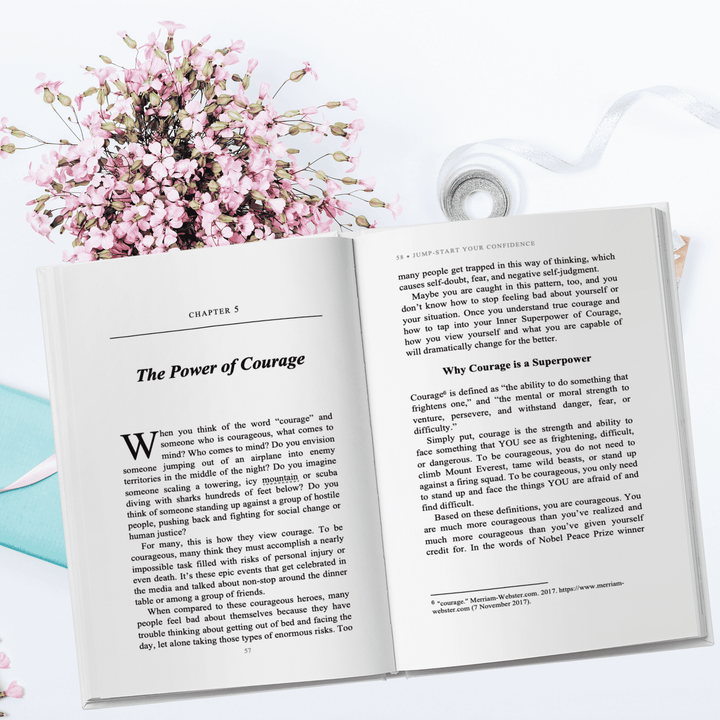 Close-up of the paperback's front cover showing vibrant title typography and textured matte finish from a 45-degree angle.