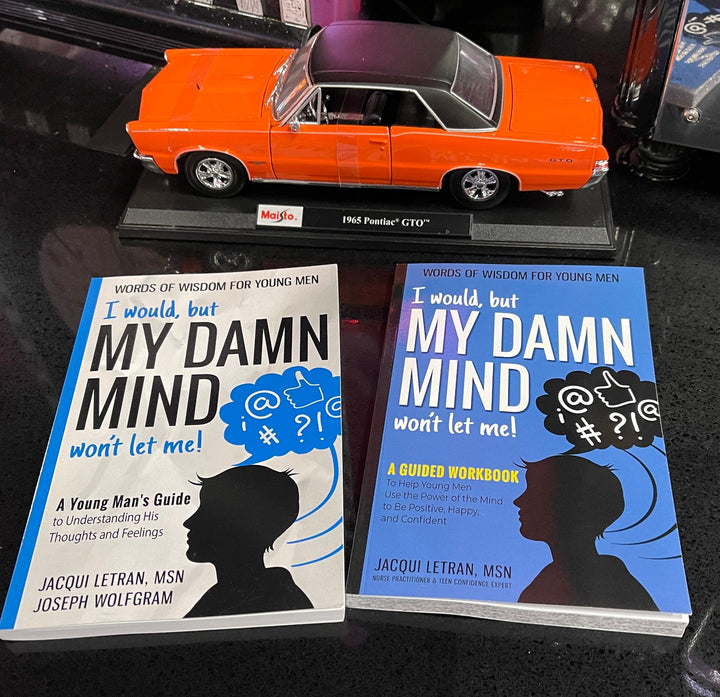 Close-up of the Teen Boys paperback book and workbook bundle showing colorful cover design and textured paper pages from a