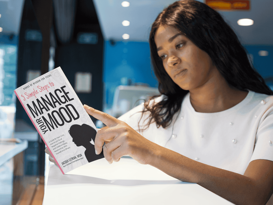 Close-up of the journal's textured light teal cover featuring embossed floral patterns and a silver foil title label on the