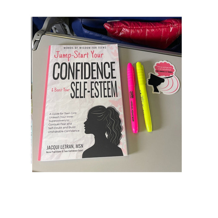 Close-up of the teal-colored journal cover with "Confidence" embossed in gold lettering, showing textured material detail.